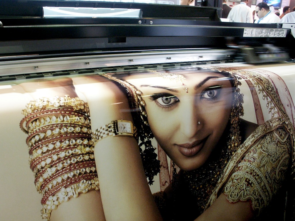Close-up of a woman's face adorned with traditional jewelry and intricate clothing, showcasing digital printing.
